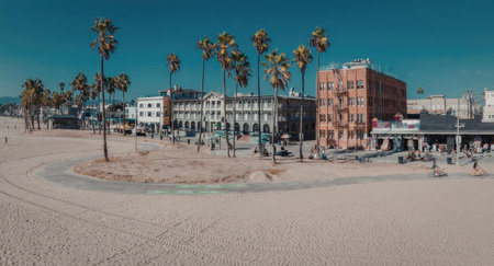 A scenic view of a beachside cityscape with palm trees, buildings, and a clear blue sky.