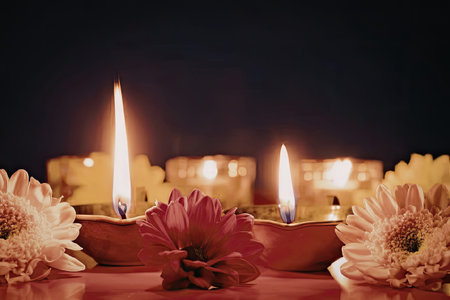 Celebrating diwali with lit candles and beautiful flowersの写真素材