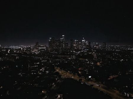 A dark cityscape at night with tall buildings and many lights