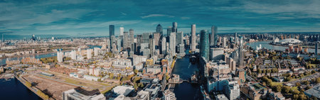 A panoramic view of a city skyline with a river running through it, surrounded by numerous buildings...