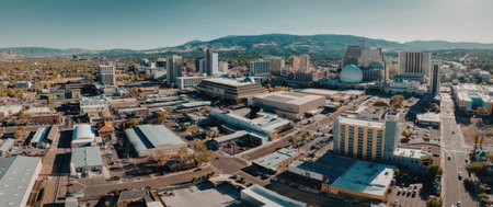 Aerial view of a city with buildings and mountains in the background