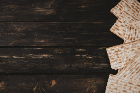 The image features a stack of crackers on a dark brown wooden table, with the table's texture...