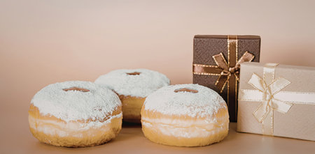 The image features three powdered donuts alongside two elegantly wrapped gift boxes, one in brown...