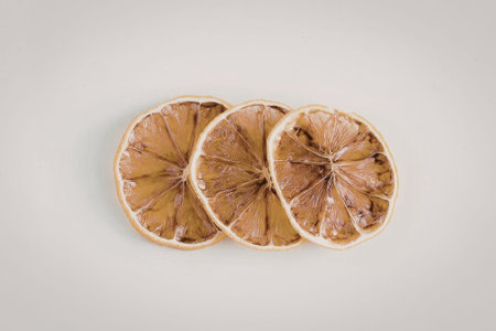 Three dried orange slices on a white background