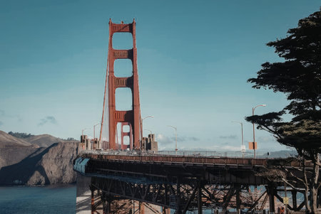 The iconic Golden Gate Bridge stands tall under a clear blue sky, showcasing its striking orange...