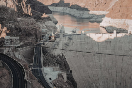 The image depicts the Hoover Dam, a large concrete dam on the Colorado River.