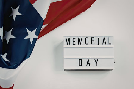 A lightbox sign with Memorial Day text next to an American flag on a white background.