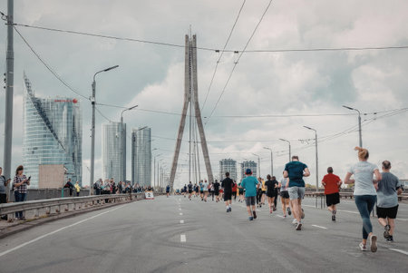 A group of people running on a bridge with a cityscape in the background