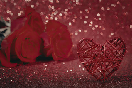 Romantic red roses and heart shape on sparkly backgroundの写真素材