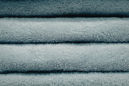 Soft blue towels stacked neatly for bathroom use