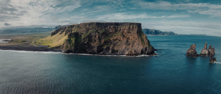The image depicts a stunning coastal landscape with a large, flat-topped cliff surrounded by water....