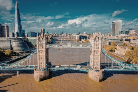 An iconic view of Tower Bridge in London, showcasing its majestic towers and blue bridge structure...