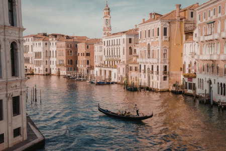 A serene view of a Venice canal with a gondola and traditional buildingsの写真素材