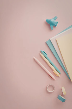 A collection of colorful stationery items, including pens, pencils, paper clips, and sticky notes,...