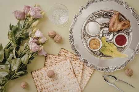 A traditional Passover Seder plate with matzah, charoset, maror, and other symbolic foods,...