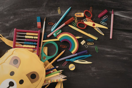 A collection of vibrant school supplies, including crayons, scissors, pencils, and an abacus,...