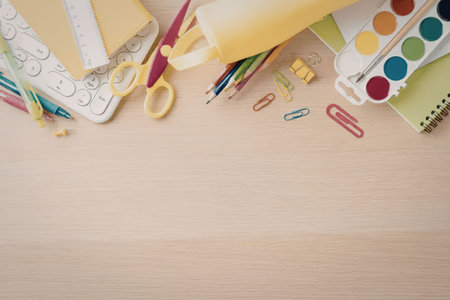A collection of school supplies, including notebooks, scissors, pencils, paint, and paper clips,...