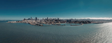 A panoramic view of San Francisco's cityscape by the bay, showcasing the city's skyline and waterfront on a sunny day.