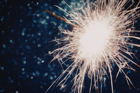 Sparkler shining brightly in the dark blue background