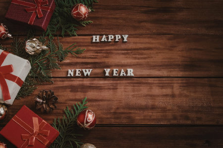A festive arrangement of gifts and decorations on a wooden background with the text 'HAPPY NEW YEAR'