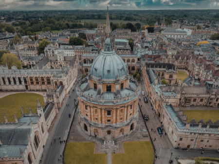 The image shows an aerial view of the Radcliffe Camera, a historic building in Oxford, England. The building features a large central dome and is surrounded by other structures and green spaces.