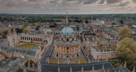 An aerial view of a historic university campus featuring a large domed building surrounded by traditional architecture and green spaces.