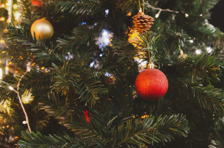 A closeup view of a christmas tree with ornaments and lights