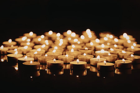 a large group of lit candles in the dark
