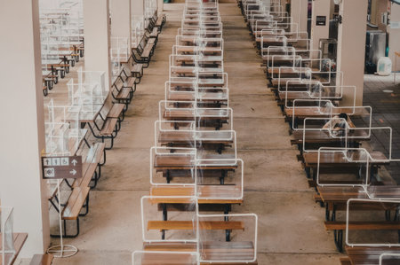 a long row of tables and chairs in a restaurant with a green and brown floor