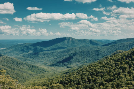 a pixelated image of a mountain range with trees and a blue sky with white clouds