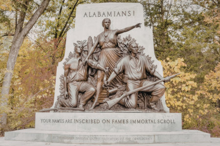 a statue of a man with a sword standing in front of a group of people with a sword and a rifle the man is pointing to the right with his right hand and holding a sword in his left hand the group of people are sitting and standing around him with some of them holding swords and rifles the statue is made of stone and has an inscription on it the background is a forest with trees and bushes