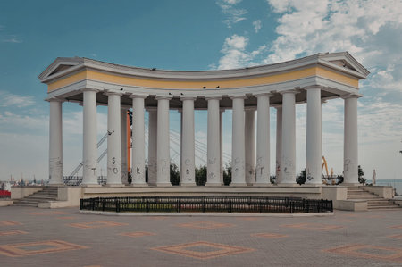 a large stone building with many columns in front of a blue sky