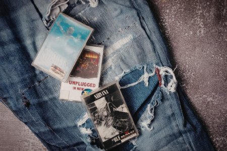 A pair of ripped blue jeans with various items on a gray surface
