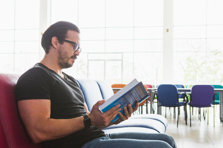 man reading on sofaの写真素材