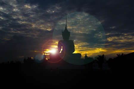 Silhouette of Buddha in a temple at Thailand eveningの写真素材