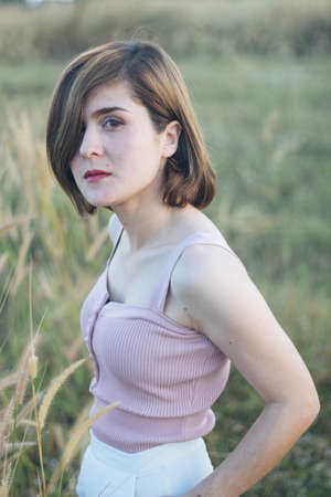 Silhouette of a young woman relaxing on a beautiful sunset. Woman enjoying nature sunset.の写真素材