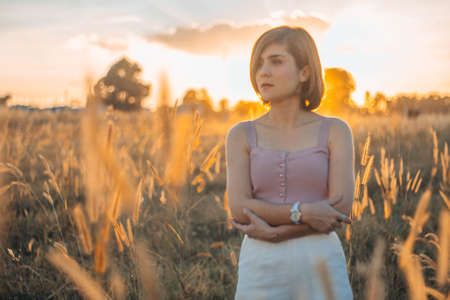 Silhouette of a young woman relaxing on a beautiful sunset. Woman enjoying nature sunset.の写真素材