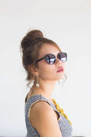 Beautiful young  model applying lipstick