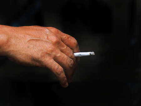 Close up picture of cigarette with hand.の写真素材