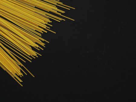 Fusilli and Spaghetti pasta on a black backgroundの写真素材