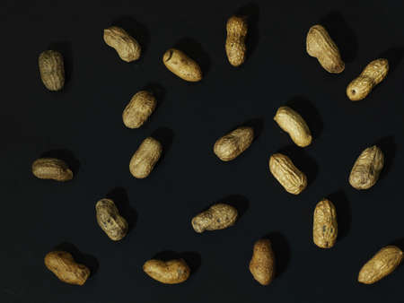 roasted peanuts on a black backgroundの写真素材