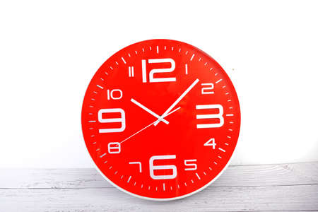photo of a red clock on a white background