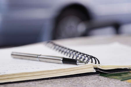 photograph using a pen to write a bookの写真素材