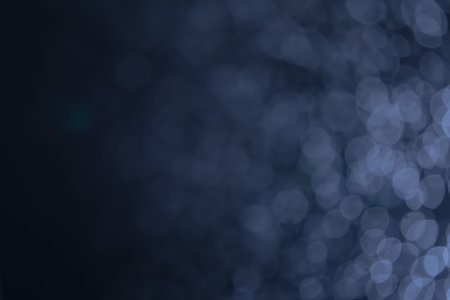 A dark blue background bokeh image for used to decorate background.の写真素材