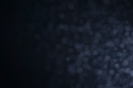 A dark blue background bokeh image for used to decorate background.の写真素材
