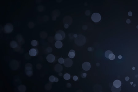 A dark blue background bokeh image for used to decorate background.の写真素材