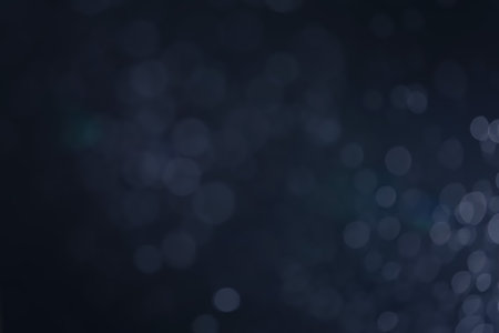 A dark blue background bokeh image for used to decorate background.の写真素材