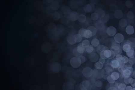 A dark blue background bokeh image for used to decorate background.の写真素材