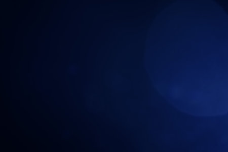 A dark blue background bokeh image for used to decorate background.