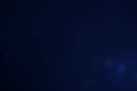 A dark blue background bokeh image for used to decorate background.の写真素材